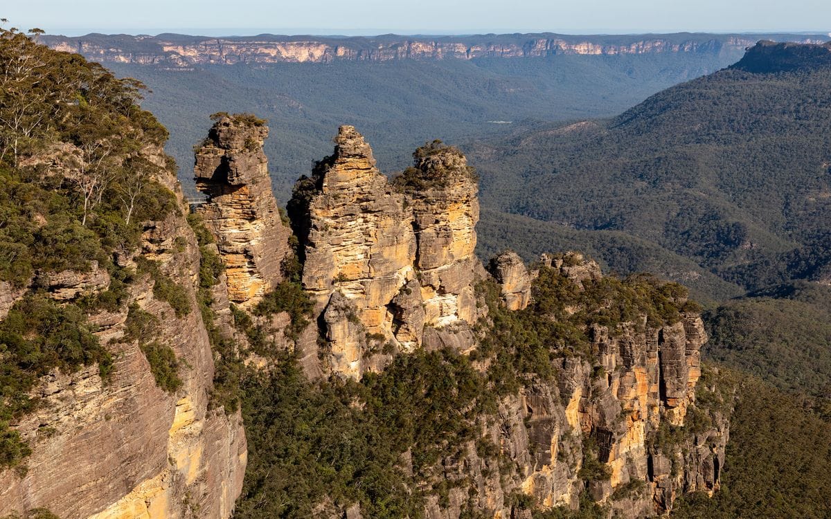 The Three Sisters sandstone formation above the forested Jamison Valley in the Blue Mountains